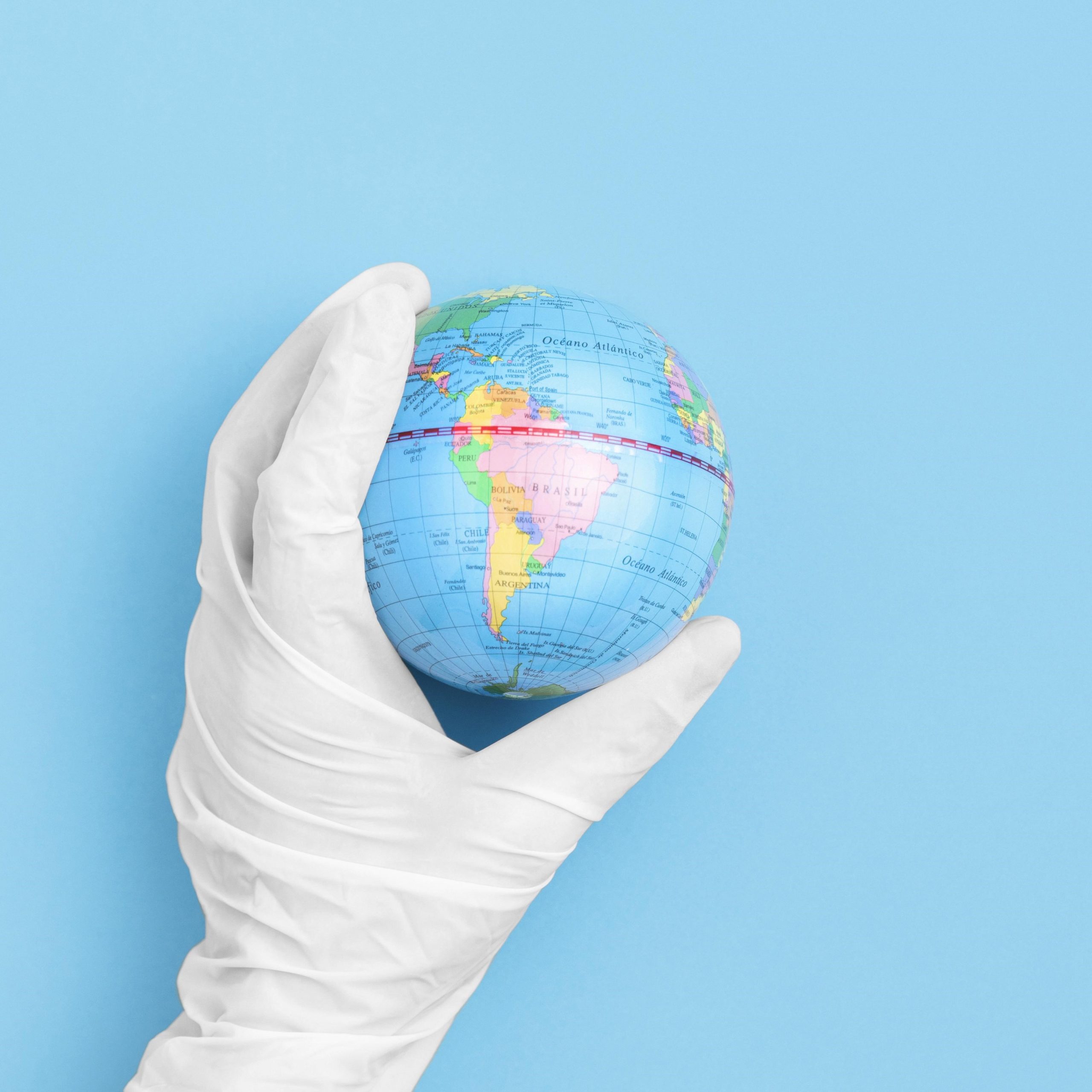 top-view-hand-with-surgical-glove-holding-globe